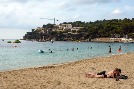 Magaluf, Mallorca, July 2019. A wide sandy beach on the island of Mallorca in the early morning. Beautiful views of the sea, mountains, sky and the hotels of the Magaluf resort. Relax.のeditorial素材