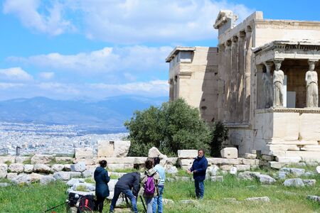 Athens, Greece, April 2019. The oldest temple on the Acropolis, built in honor of the divine patroness of the city - Hekatompedon. Athens. The film crew records an interview about the attraction.のeditorial素材