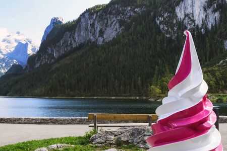 Ice cream advertising mockup on the background of the Austrian landscape. Lake, mountains with snow...