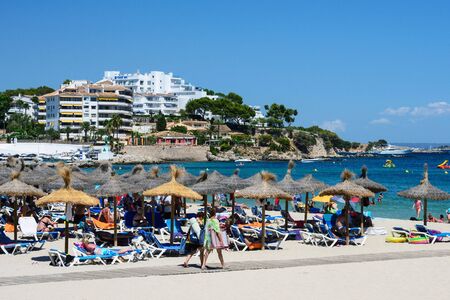 Palma Nova, Mallorca, July 2019. Wide sandy beach on the island of Mallorca in the early morning. Beautiful views of the sea, the sky and the tourists. Relax. Balearic Islands.のeditorial素材