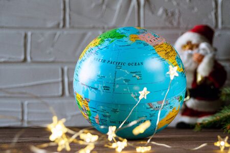 Globe, spruce branches and garland cones create a New Year's mood. Merry christmas and happy new...