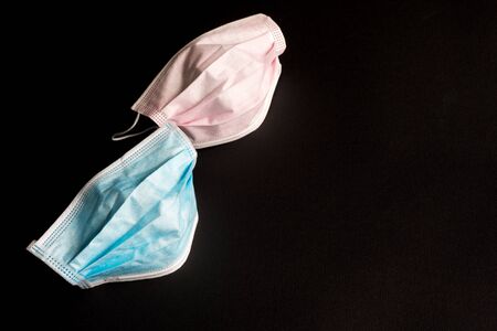 Two medical disposable protective masks on a black background. Virus protection. の写真素材