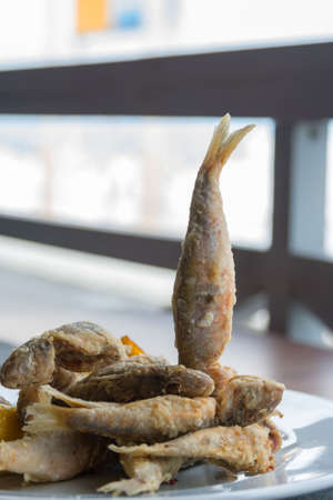 Crispy fried fish on a white background. Tasty mullus in a restaurant in Odessa. Traveling in Ukraine.の写真素材