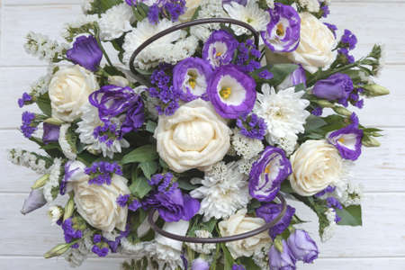 Beautiful bouquet of white and purple flowers on a white background. Flower arrangement for your beloved.の写真素材