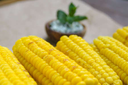 Young yellow sweet corn on the grill. Delicious summer meal. Closeup.の写真素材