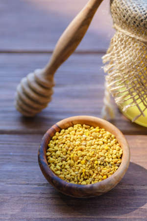 Bee pollen in a wooden plate. A valuable and useful beekeeping product and a natural antiseptic.