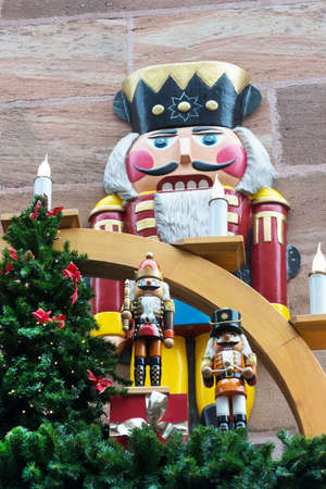 New Year tree and tin soldier on the background of a brick wall. Decorations on the street on the...