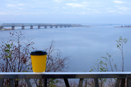 Bridge and dam across the Dnieper river on a cloudy day. Autumn dull landscape. Travel across...