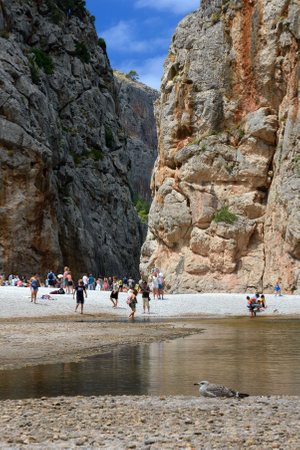 Spain, Mallorca, July 2019. Beautiful beach, rocky mountains in the gorge and bay of Sa Calobra, Spain. Travel to Majorca island.のeditorial素材