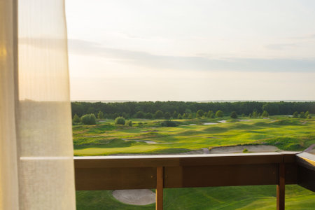 View from the balcony to the green beautiful golf course. beautiful sunset. Travel Ukraine.の写真素材