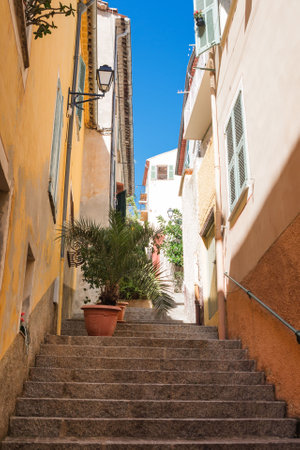 Old narrow authentic street of the city of Villefranche-sur-Mer in the French Riviera resort....
