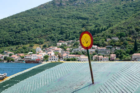Ferry crossing Kamenari-Lepetani Montenegro in the Bay of Kotor. View of the mountains, houses from the ferry. TravelMontenegro.の写真素材