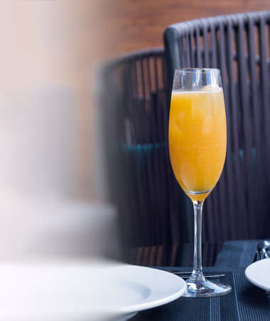 A glass of orange freshly squeezed natural juice on a table in a restaurant. Proper nutrition. vertical composition.の写真素材