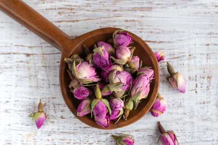 Pink rose buds close-up on a white background. Tea from the Rosa Rugosa plant. View from above.の写真素材