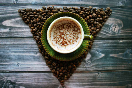RUSSIA - AUGUST 15,2020: Coffee with milk froth surrounded by coffee beans.の写真素材