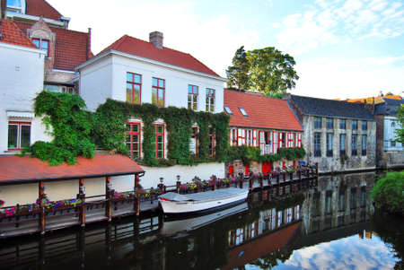 BELGIUM - JULY 2010: Beautiful old houses on the embankment of Bruges, Belgium.のeditorial素材