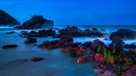 Long exposure of rocks in the sea at dusk. Bali, Indonesiaの写真素材