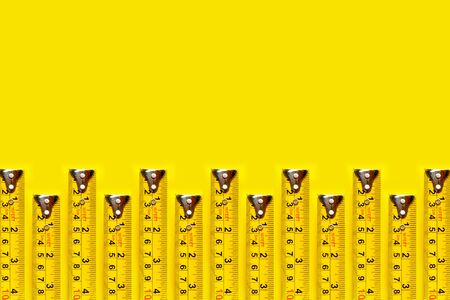 Frame yellow measuring tape on yellow background and texture.の写真素材