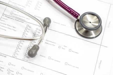 Doctor's desk with patient medical history from and stethoscope is placed.の写真素材