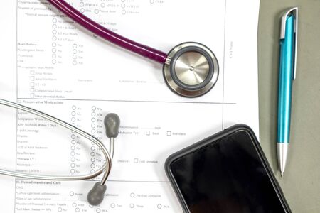 Doctor's desk with patient medical history from and stethoscope is placed.