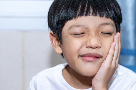 Asian little boy is doing a terrible toothache. Portrait a little boy suffering from toothache. Oral Care Conceptsの写真素材