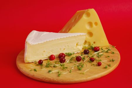 Piece of cheese on a red backgroundの写真素材