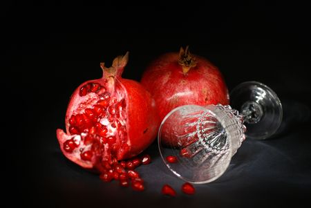 Pomegranate and wine glass on black backgroundの写真素材