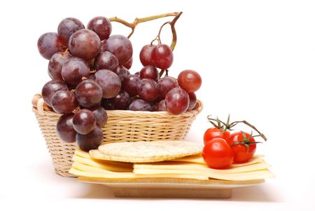 Different kinds of cheese, tomatoes and grapesの写真素材