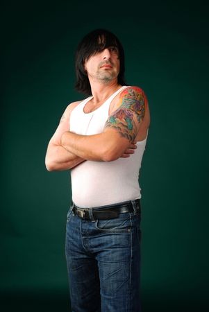 Portrait of handsome standing men at green backgroundの写真素材