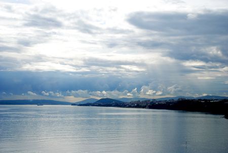 Blue sky above a blue surface of the seaの写真素材