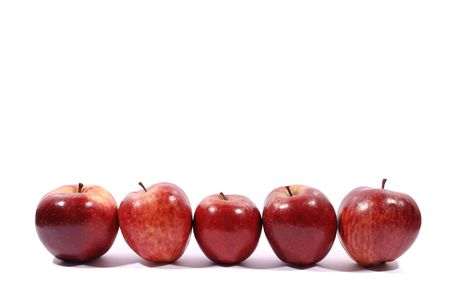 Apples in a row on white with natural shadow. の写真素材