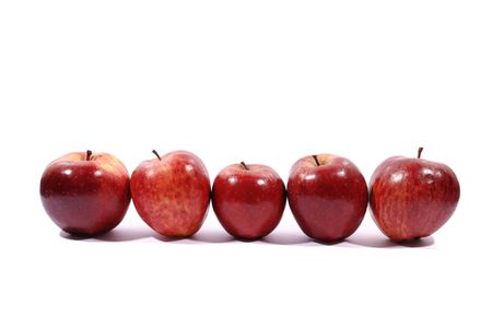 Apples in a row on white with natural shadow. の写真素材