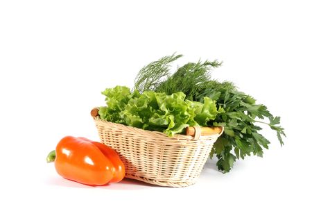 Parsley, dill, pepper and lettuce in basket on white backgroundの写真素材