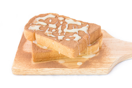 Spreading chocolate power and sweet milk on breads.