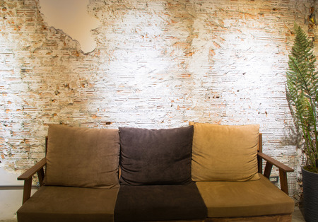Brown sofa and white broken wall in modern room.の写真素材