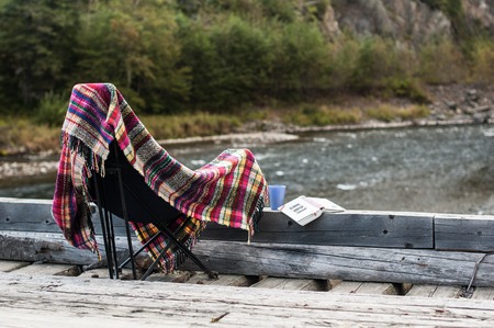Rest with a book on wooden bridge on natural backgroundの写真素材