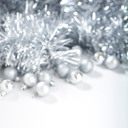Defocused christmas background with silver christmas balls and tinsel. Square format.の写真素材