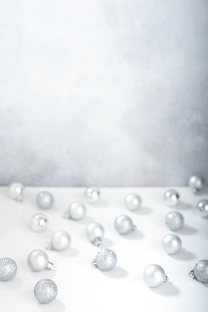 Defocused christmas background with silver christmas ballsの写真素材