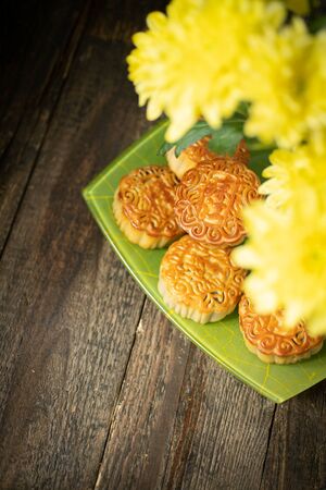 Mooncakes, yellow chrysanthemum flowers. Chinese mid-autumn festival food.の写真素材