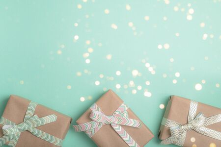 Gift boxes with ribbons on turquoise background. Holiday concept.の写真素材