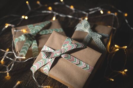 Gift boxes with ribbons on wooden
