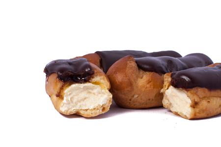 delicious Cake eclair custard is broken in half isolated on whiteの写真素材