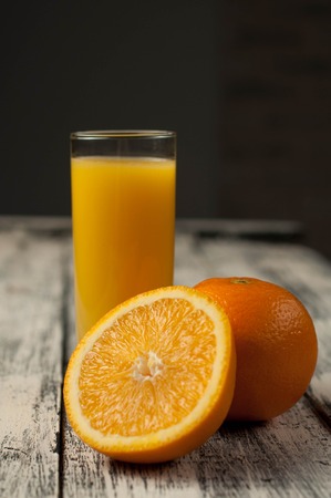 fresh Orange fruit cut and orange juice on wooden table background,の写真素材