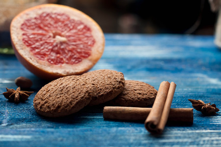 grapefruit, cinnamon and oatmeal cookies on vintage a dark blue wooden backgroundの写真素材