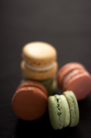 Delicious multicolored cake macaron or macaroon on black background.Various colour macarons.の写真素材