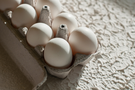 Eggs in the package on white table backgroundの写真素材
