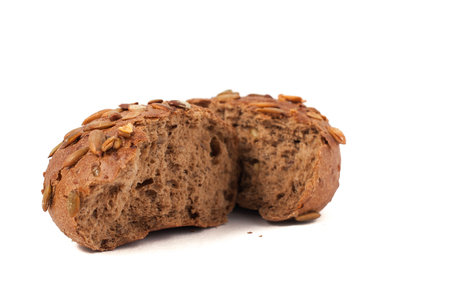 small round a bun with pumpkin seeds wherein is isolated on a white backgroundの写真素材