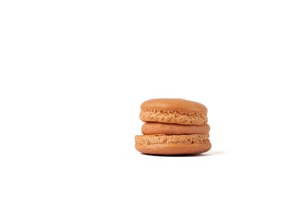Tasty brown macaron isolated on white.の写真素材