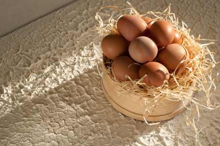 sieve full of easter eggs on rustic woodの写真素材