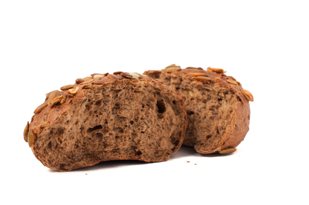 small round a bun with pumpkin seeds wherein is isolated on a white backgroundの写真素材